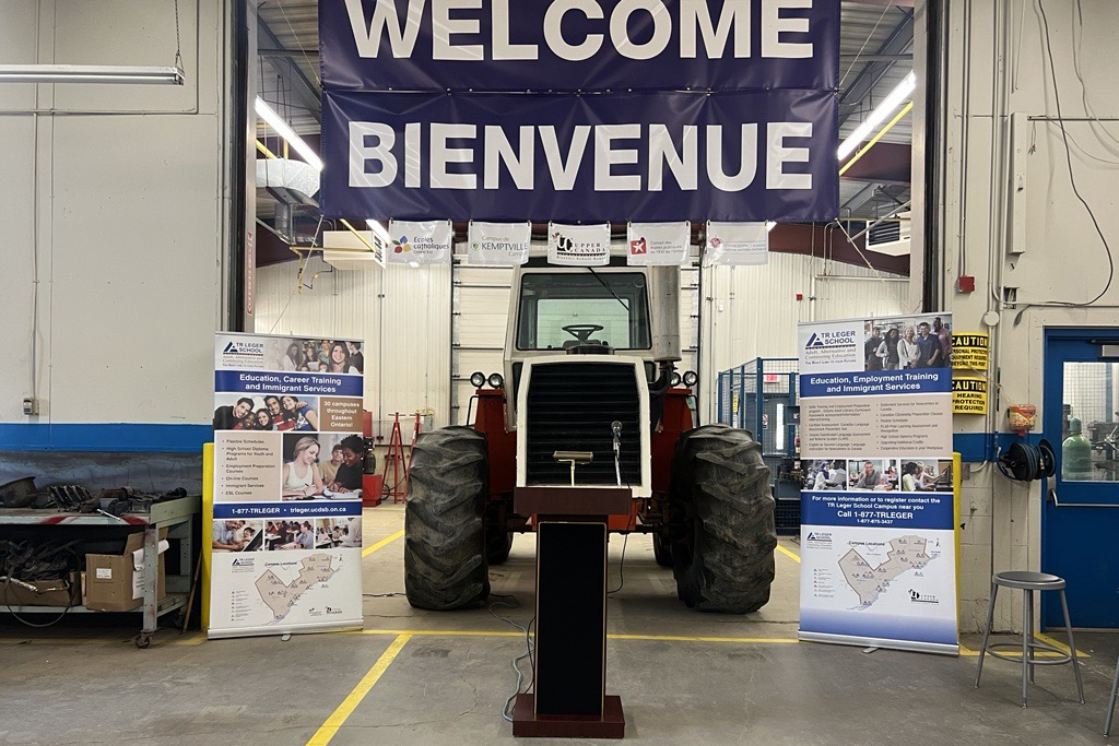 TR Leger Shop with a tractor and welcome sign.