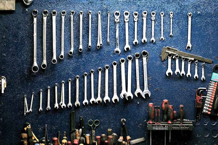 A set of wrenches on a blue background.